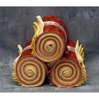 Decorative item resembling a bouquet of red and yellow spiral-patterned rolls on a gray background