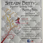 Advertisement for Steady Betty Inc. Betty Bits quilting tools with decorative elements on a textured background.