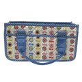 A quilted fabric organizer bag with a colorful floral and bow pattern on a cream background, framed by blue striped borders and solid blue handles, shown against a plain white background.