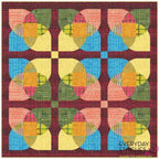 Colorful quilt with geometric pattern on a red background, featuring the brand 'Everyday Stitches'.